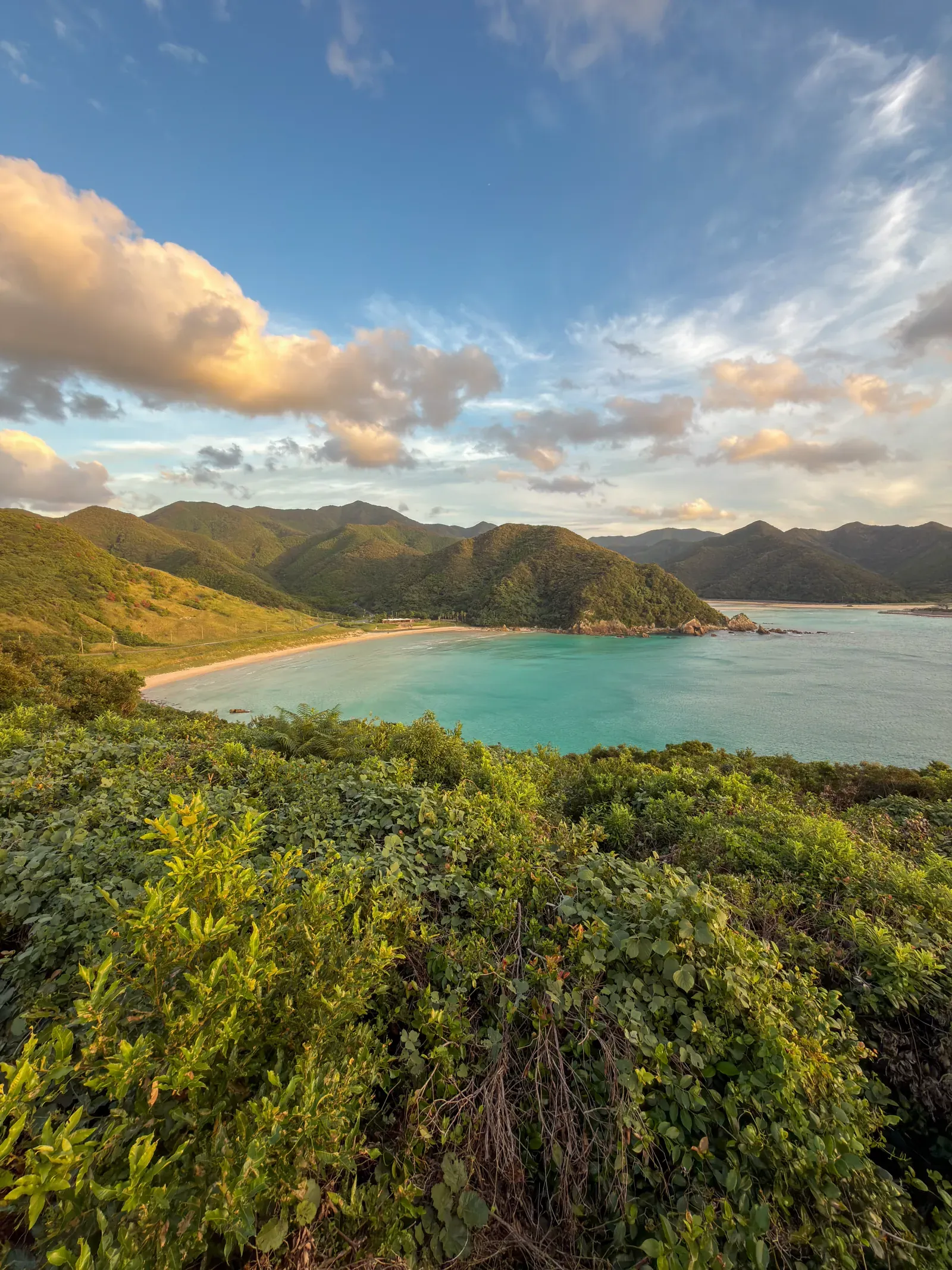 A coastal bay in the Gotō Islands: green headland, turquoise shallows