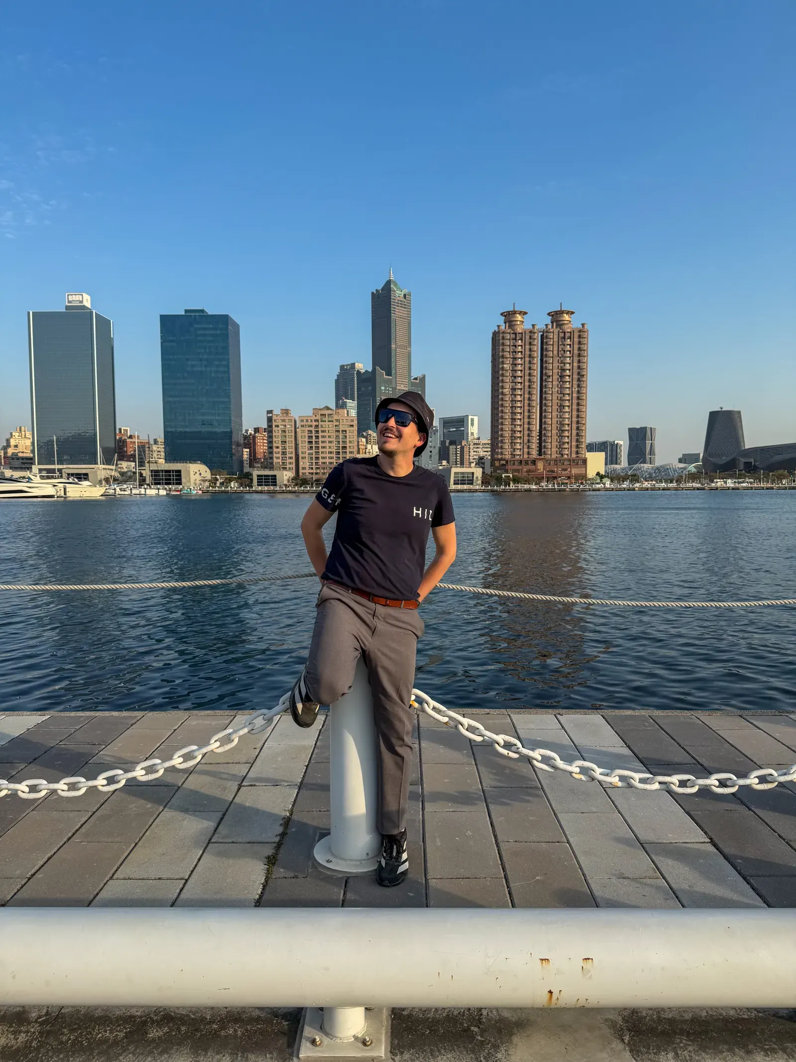 A person on the Kaohsiung waterfront, the city skyline behind